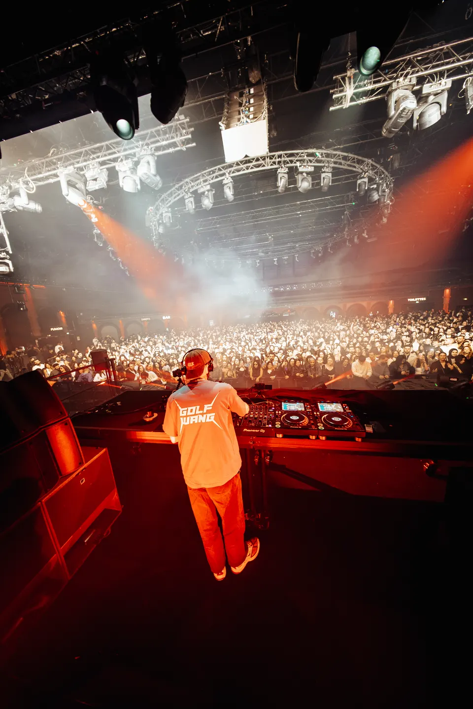 Meloko on stage in front of a packed hall